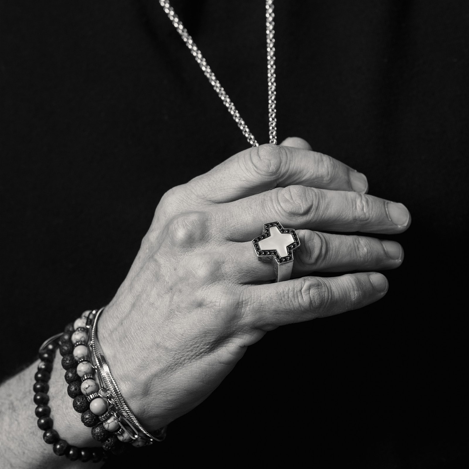 Rob Seaman holding his necklace in one hand
